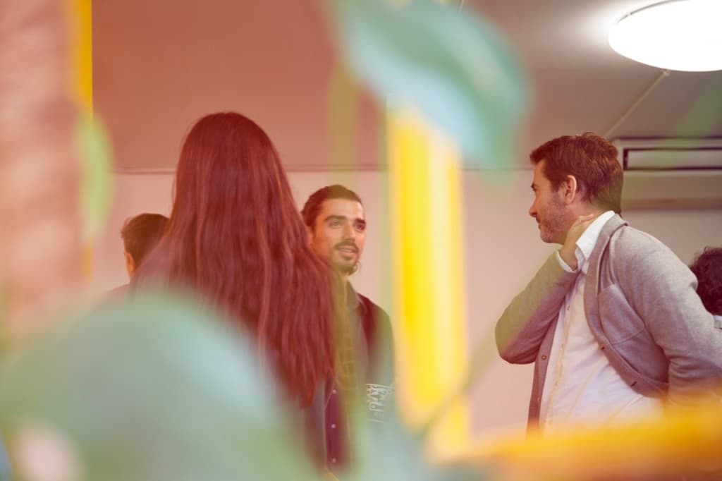 People talking together at an indoor pavilion gathering